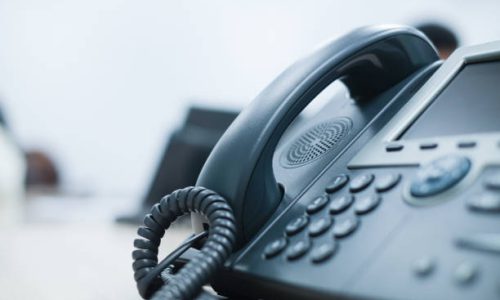 istockphoto-992782254-612×612-1 close up soft focus on telephone devices at office desk for customer service support concept